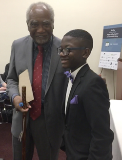 Rep. Danny Davis speaks with Joshua Grandy, a musician from Baltimore Symphony Orchestra’s OrchKids program, at a 2017 charitable giving briefing in Washington, D.C.