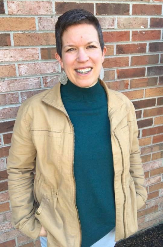 Photo of Sonja Thoms standing in front of a brick wall